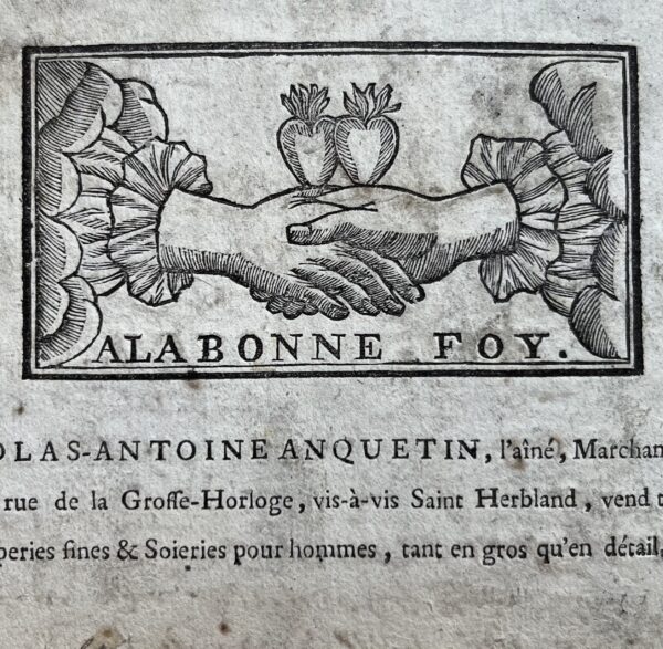 Belle carte publicitaire du XVIIIe du drapier rouennais Nicolas-Antoine Anquetin, ornée d'une fides